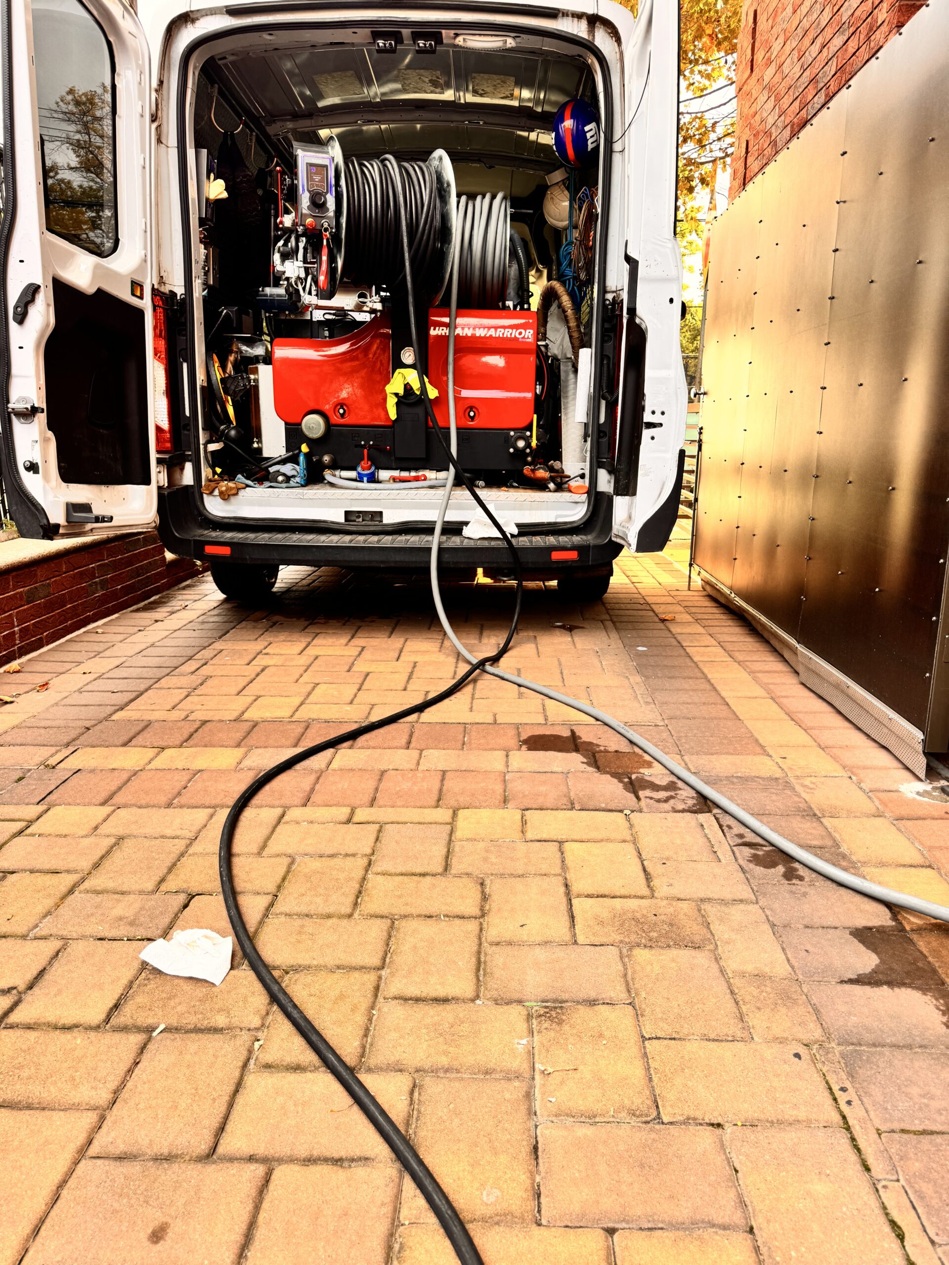 Coiled hoses are inside the van with safety gear